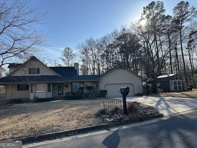 view of front of house featuring a storage shed and a garage