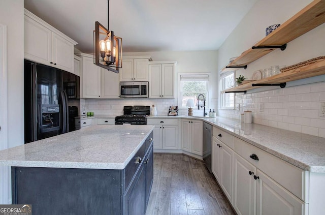 kitchen with sink, light hardwood / wood-style flooring, white cabinetry, hanging light fixtures, and black appliances