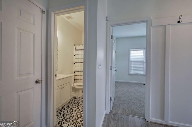 hallway with light hardwood / wood-style floors