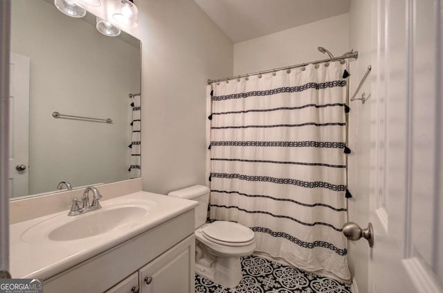 bathroom with tile patterned flooring, vanity, and toilet