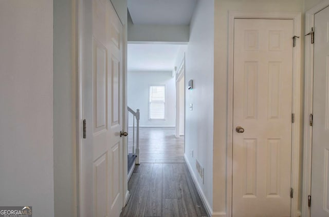 corridor featuring dark hardwood / wood-style floors