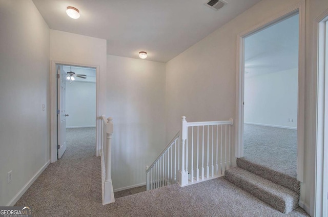 hallway featuring light carpet