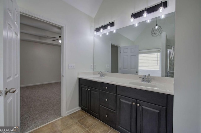 bathroom featuring lofted ceiling, vanity, tile patterned flooring, and ceiling fan