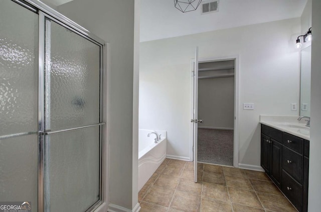 bathroom featuring vanity and shower with separate bathtub