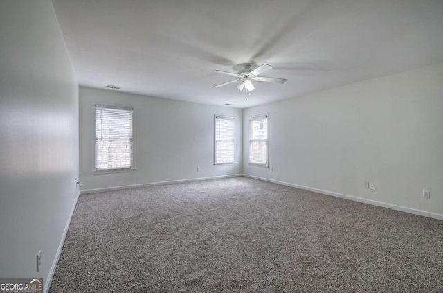 empty room featuring ceiling fan and carpet flooring