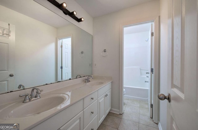 bathroom featuring vanity, tile patterned floors, and toilet