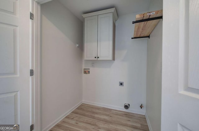 clothes washing area with electric dryer hookup, cabinets, washer hookup, hookup for a gas dryer, and light wood-type flooring