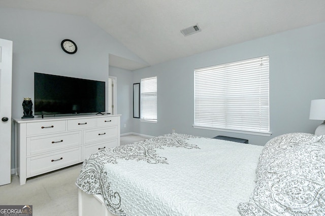 carpeted bedroom with lofted ceiling