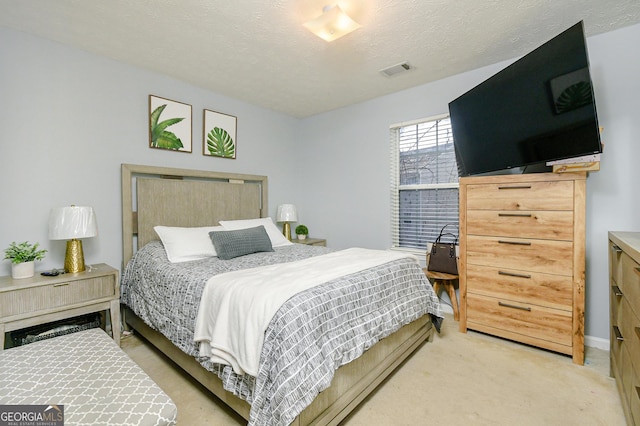 carpeted bedroom featuring a textured ceiling