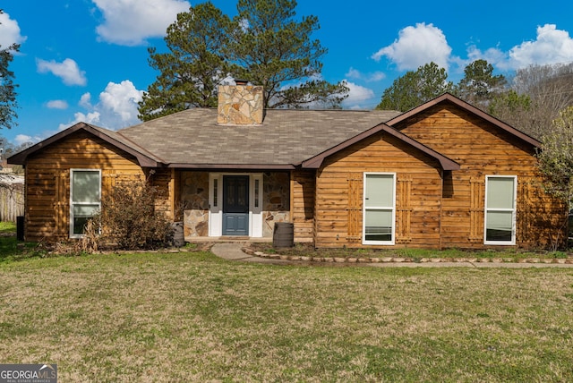 view of front facade with stone siding, a chimney, and a front yard