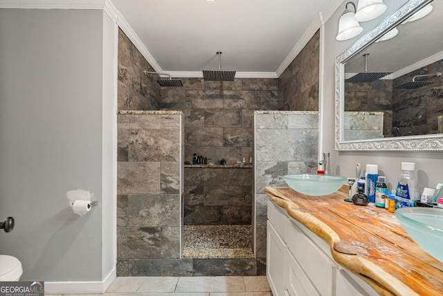 bathroom with crown molding, a walk in shower, and a sink