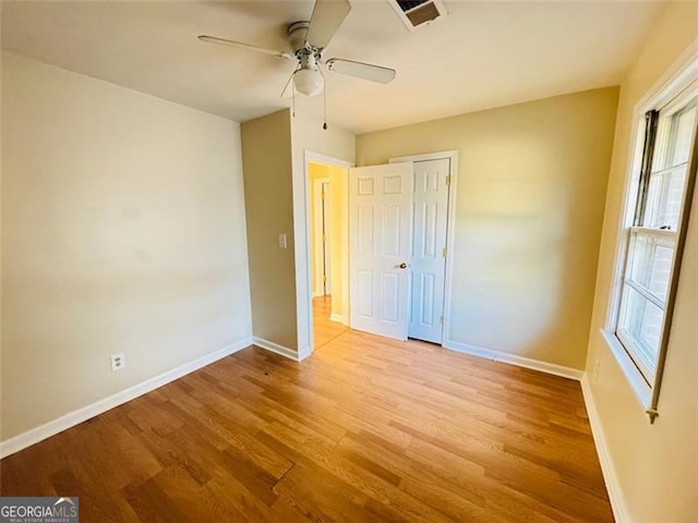 unfurnished bedroom with ceiling fan, a closet, and light wood-type flooring