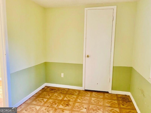 unfurnished room with parquet floors