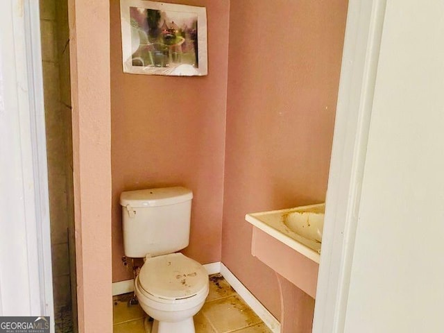 bathroom with tile patterned flooring and toilet