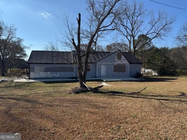 back of property featuring a yard