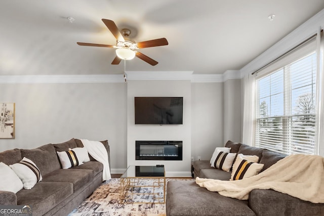 living room featuring hardwood / wood-style flooring, ceiling fan, and ornamental molding