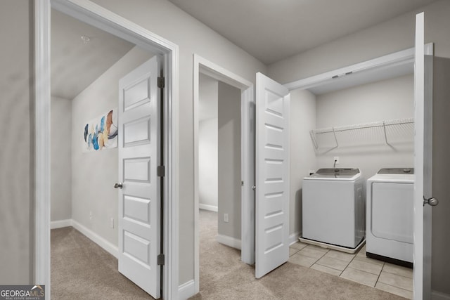 laundry area featuring washer and dryer and light tile patterned flooring