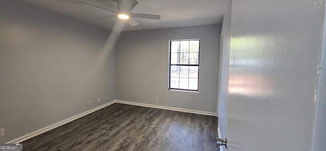 spare room with a ceiling fan, baseboards, and dark wood-type flooring