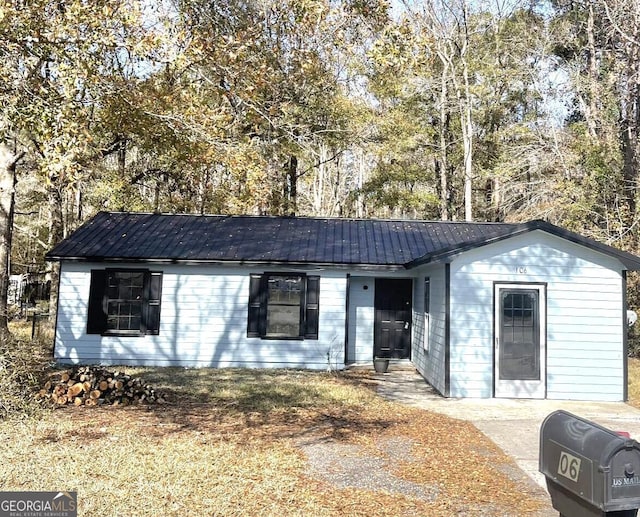 ranch-style house featuring metal roof