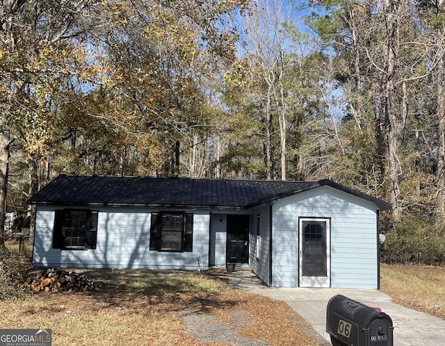 ranch-style home with metal roof