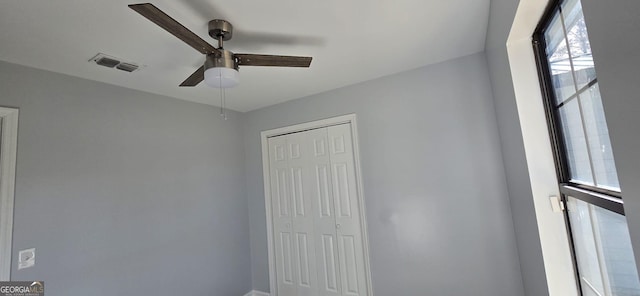 unfurnished bedroom featuring a closet, visible vents, and a ceiling fan