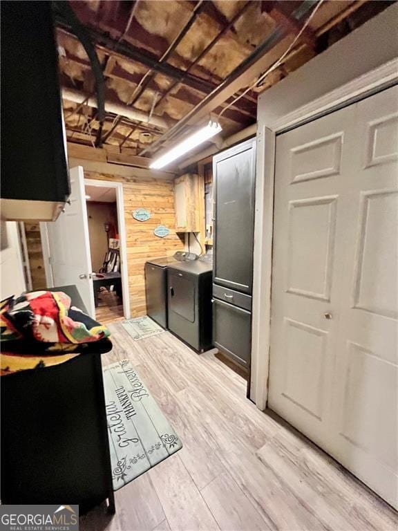 kitchen featuring wooden walls and light wood-type flooring