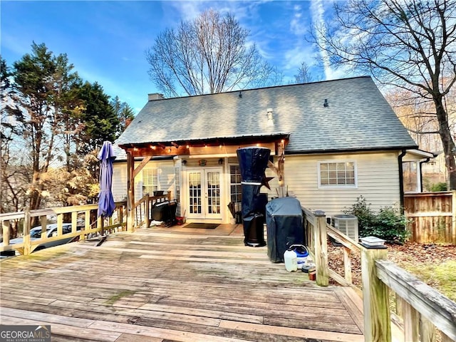 exterior space with central AC unit, french doors, and a deck