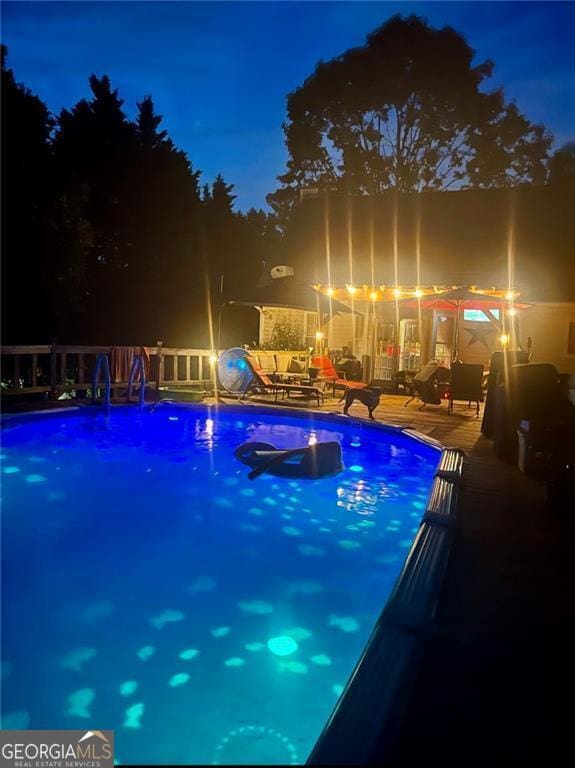 view of pool at night