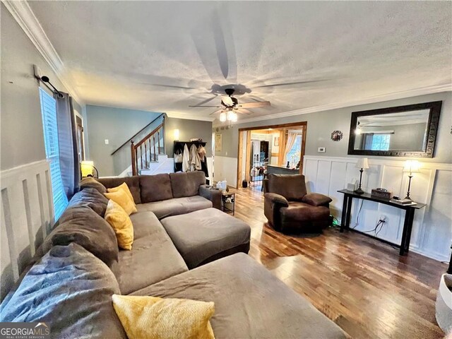 living room with crown molding and hardwood / wood-style flooring