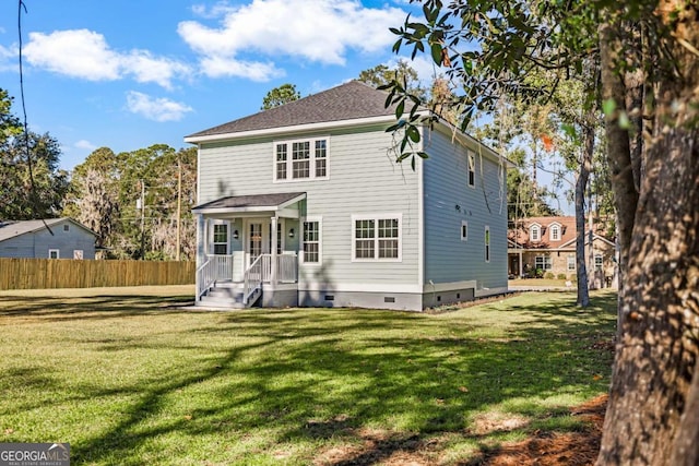 back of property featuring a yard