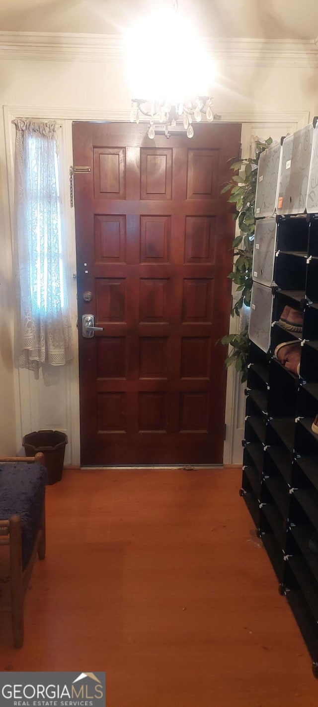 entryway featuring hardwood / wood-style flooring and ornamental molding