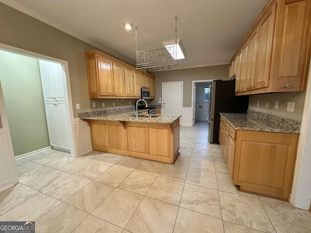 kitchen featuring light stone counters, crown molding, appliances with stainless steel finishes, a sink, and a peninsula