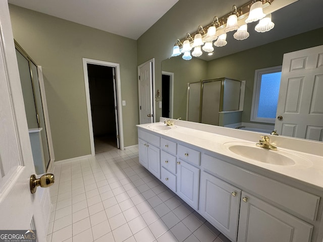 bathroom with double vanity, a stall shower, a sink, and tile patterned floors