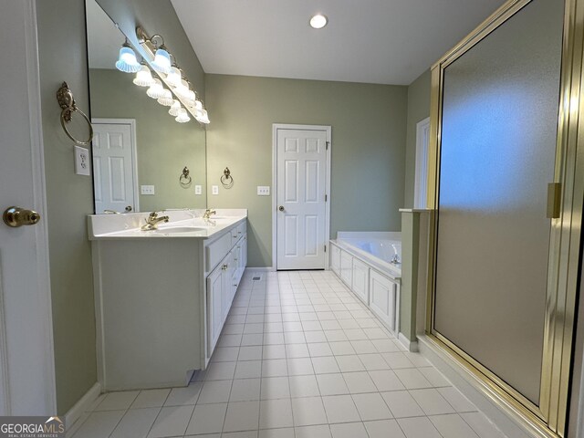 full bath featuring tile patterned flooring, a garden tub, a sink, double vanity, and a stall shower