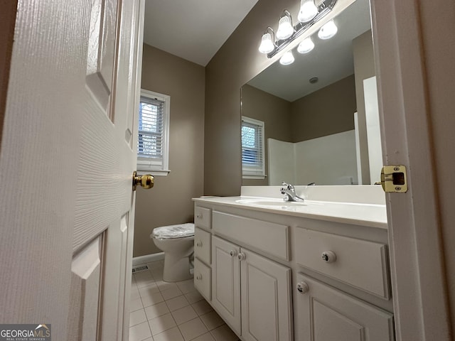 full bathroom with toilet, baseboards, vanity, and tile patterned floors