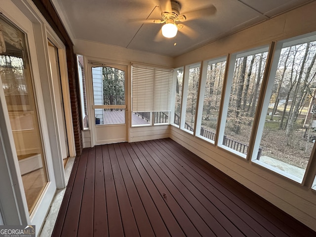 unfurnished sunroom featuring ceiling fan