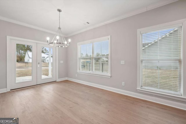 unfurnished living room with ornamental molding, ceiling fan with notable chandelier, and light hardwood / wood-style flooring