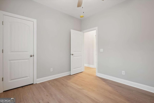 unfurnished bedroom with ceiling fan and light wood-type flooring