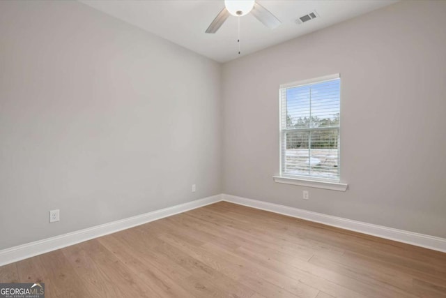 empty room with ceiling fan and light hardwood / wood-style floors