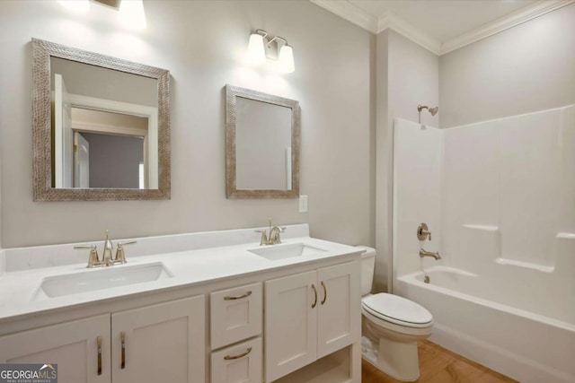 full bathroom featuring hardwood / wood-style floors, vanity, ornamental molding, bathtub / shower combination, and toilet