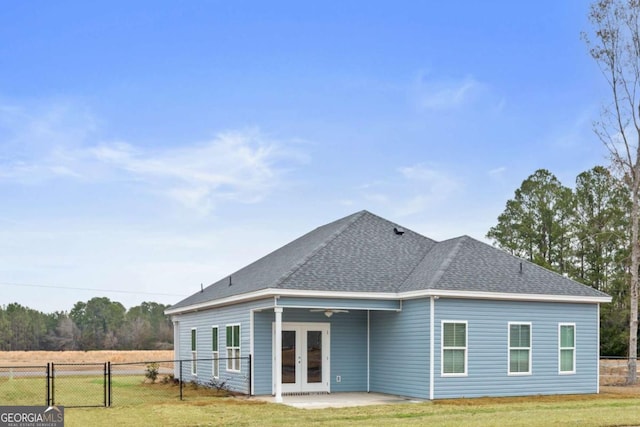 back of property with a patio, a yard, and french doors