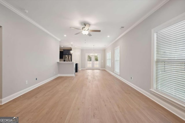 unfurnished living room featuring crown molding, ceiling fan with notable chandelier, and light wood-type flooring