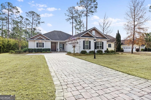 ranch-style home with a garage and a front lawn