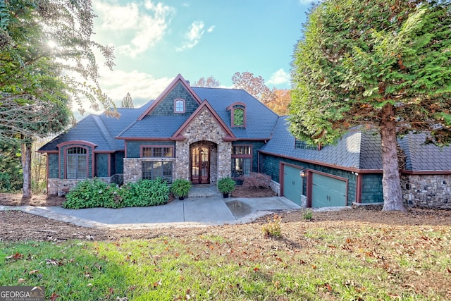 view of front of home with a garage and a front lawn