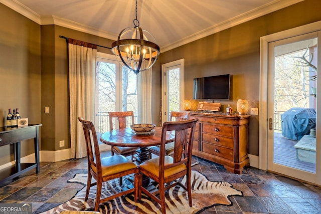 dining area featuring crown molding and a chandelier