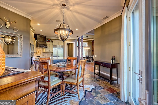 dining room featuring ornamental molding and a chandelier