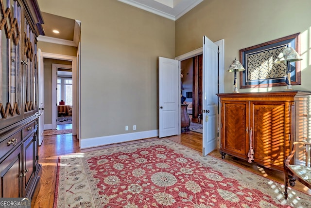 bedroom featuring hardwood / wood-style floors and crown molding