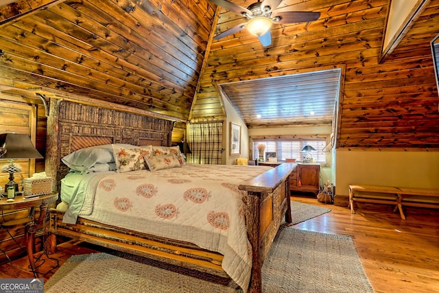 bedroom featuring ceiling fan, lofted ceiling, and light hardwood / wood-style flooring