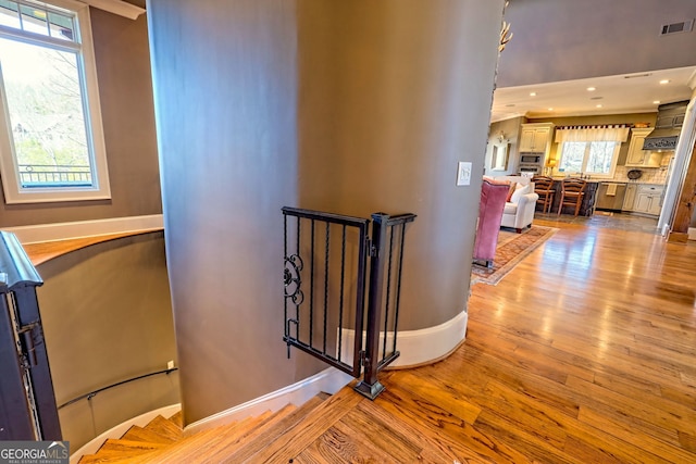 stairs featuring wood-type flooring