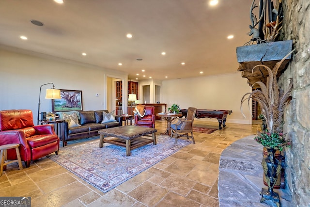 living room featuring crown molding and billiards